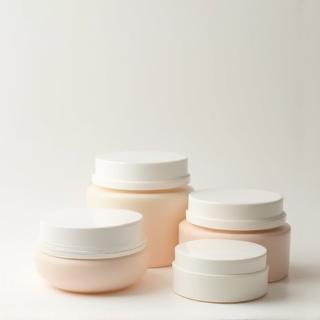 Variety of cosmetic cream and balm jars in different materials and lid types